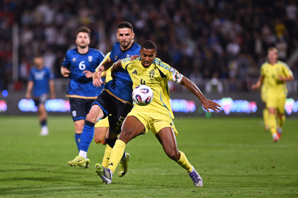 Sweden's defender #04 Isak Hien (R) fights for the ball with  Kosovo's defender #05 Lumbardh Dellova during the FIFA World Cup 2026 Group B European qualification football match between Kosovo and Sweden at the Fadil Vokrri Stadium
