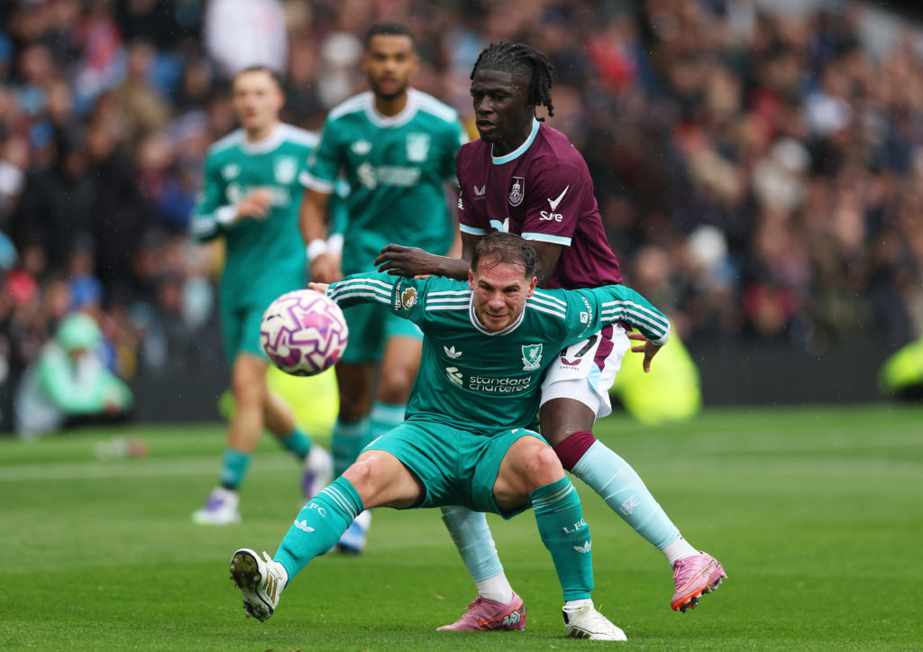 Alexis Mac Allister of Liverpool battles for possession with Loum Tchaouna of Burnley during the Premier League match between Burnley and Liverpool at Turf Moor