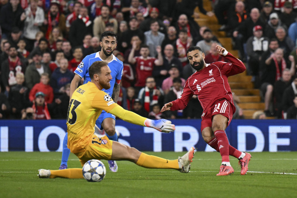 Liverpool's Egyptian striker #11 Mohamed Salah (R) celebrates scoring his team's second goal against Atletico Madrid's Slovenian goalkeeper #13 Jan Oblak.