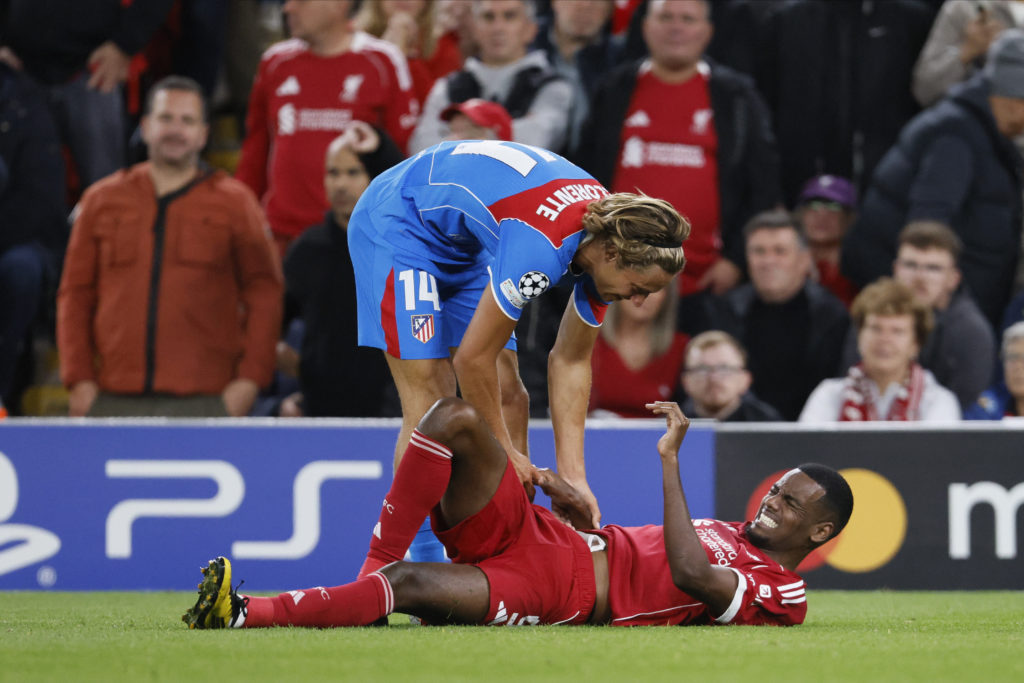 Marcos Llorente tends to Alexander Isak during Liverpool's UEFA Champions League match against Atletico Madrid at Anfield.