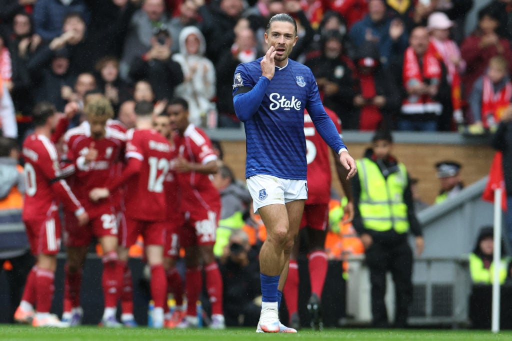 Jack Grealish looks on as Liverpool celebrate scoring against Everton in the Premier League at Anfield