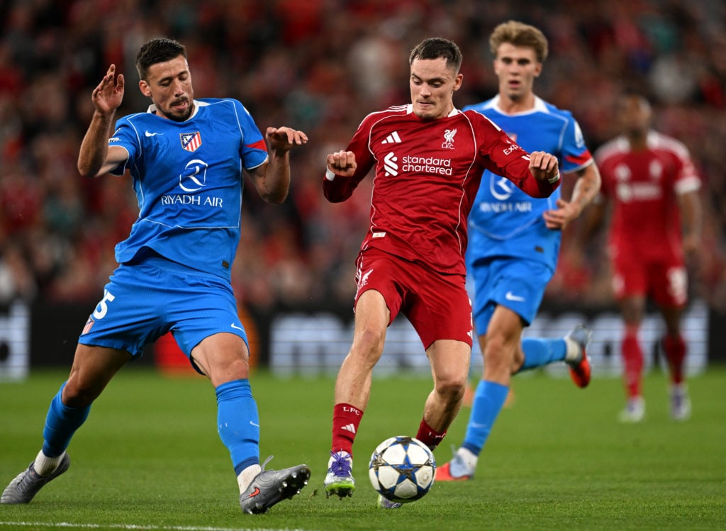 Florian Wirtz of Liverpool is challenged by Clement Lenglet of Atletico de Madrid during the UEFA Champions League 2025/26 League Phase MD1 match between Liverpool FC and Atletico de Madrid at Anfield.