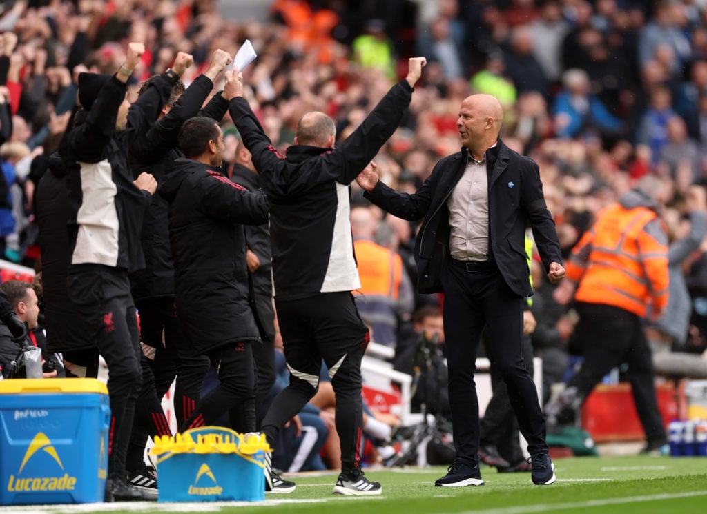 Arne Slot and the Liverpool coaching staff celebrate after their team score against Everton at Anfield in the Premier League.