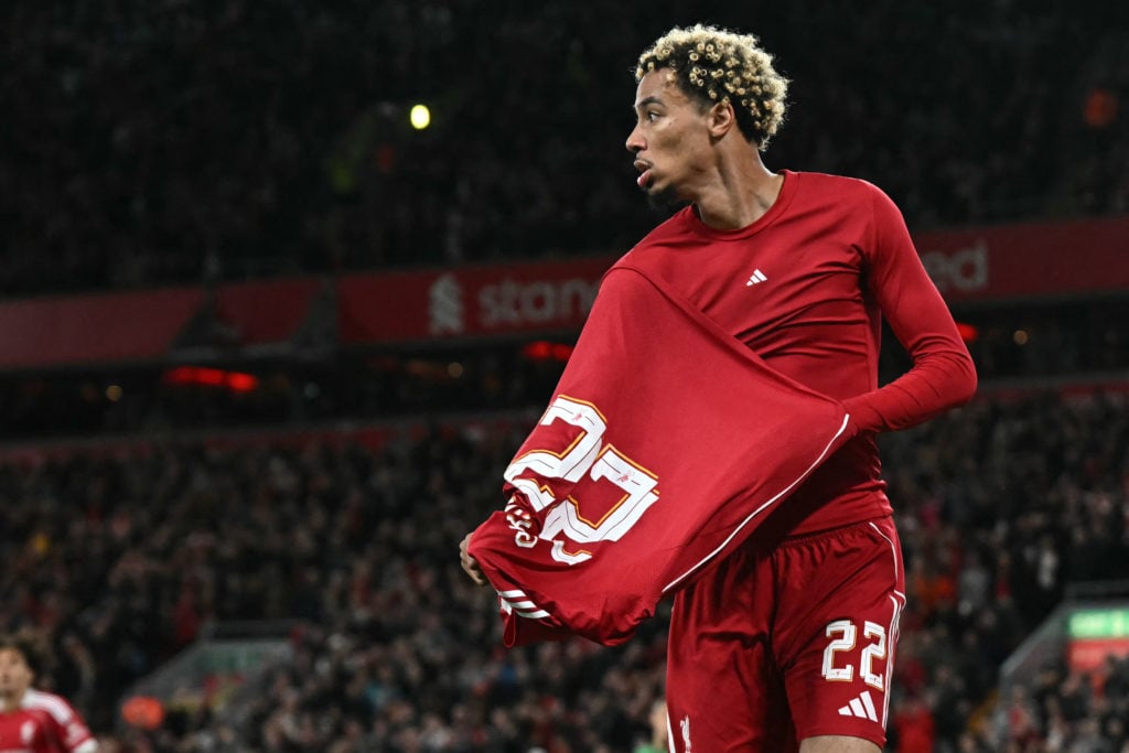 Liverpool's French striker #22 Hugo Ekitike starts to remove his shirt as he celebrates scoring their second goal, he was then sent off after picking up his second yellow card, during the English League Cup third round football match between Liverpool and Southampton at Anfield