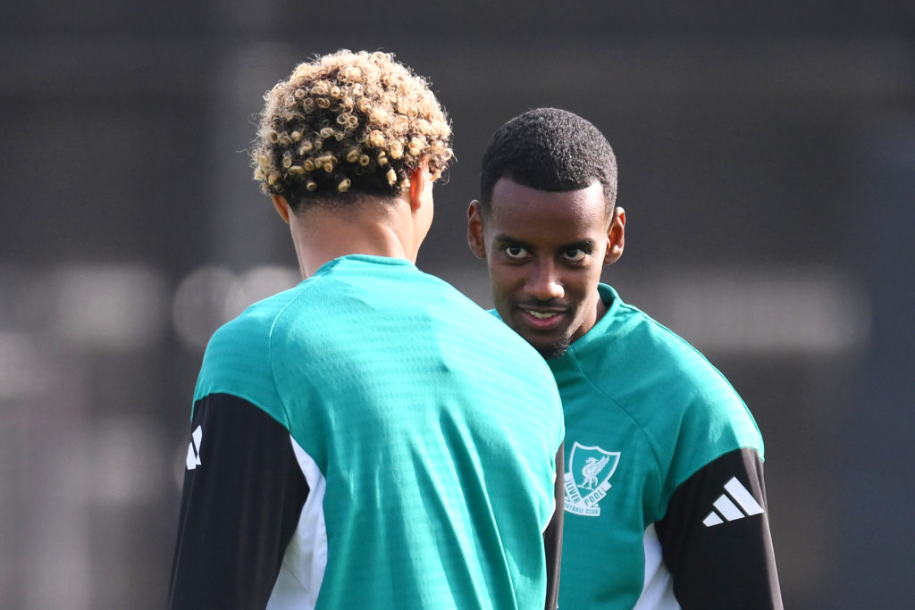 Alexander Isak talks with Hugo Ekitike during a Liverpool training session at the AXA Training Centre
