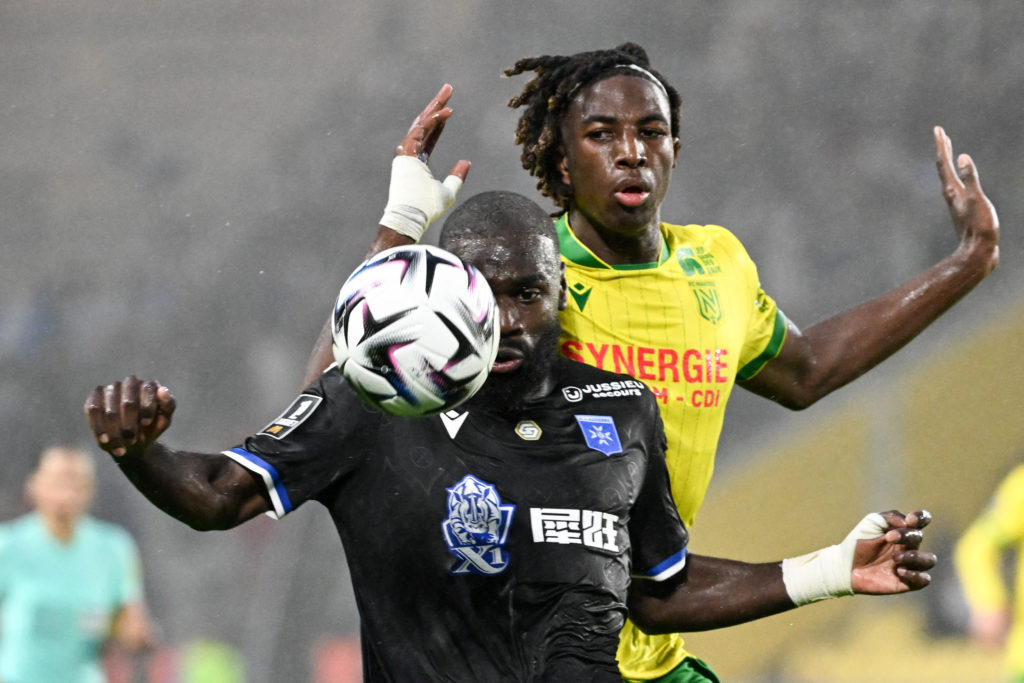 Auxerre's Malian forward #10 Lassine Sinayoko (L) fights for the ball with Nantes' French defender #78 Tylel Tati (R) during the French L1 football match between FC Nantes and AJ Auxerre at the Stade de la BeaujoireLouis Fonteneau