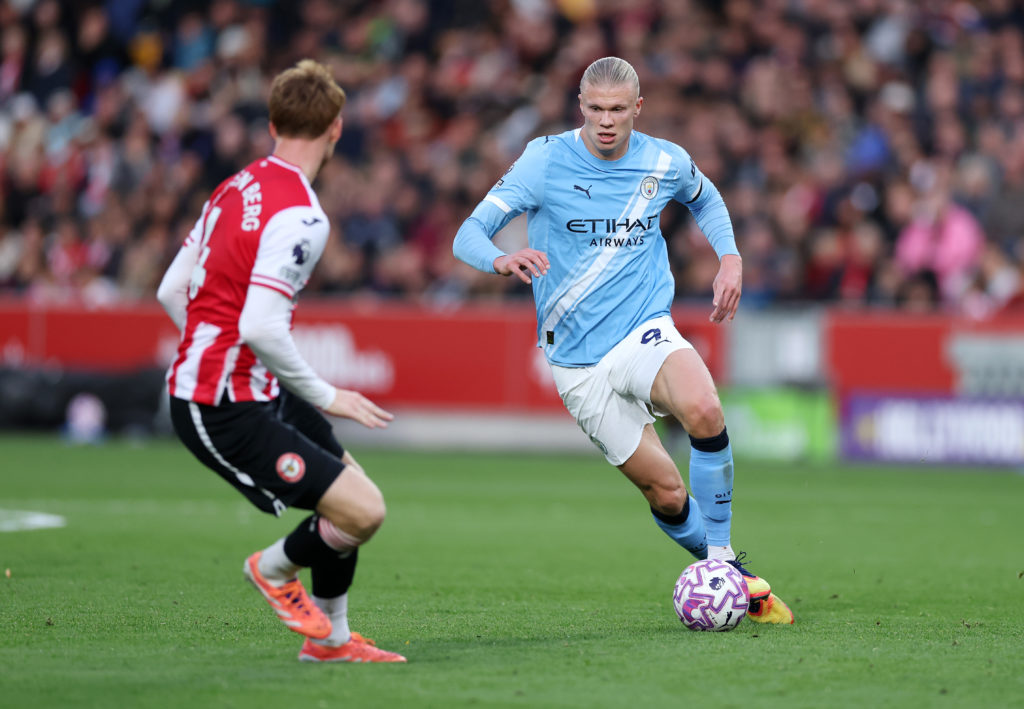 Erling Haaland runs at Sepp van den Berg during Manchester City's Premier League match against Brentford at the Gtech Community Stadium.