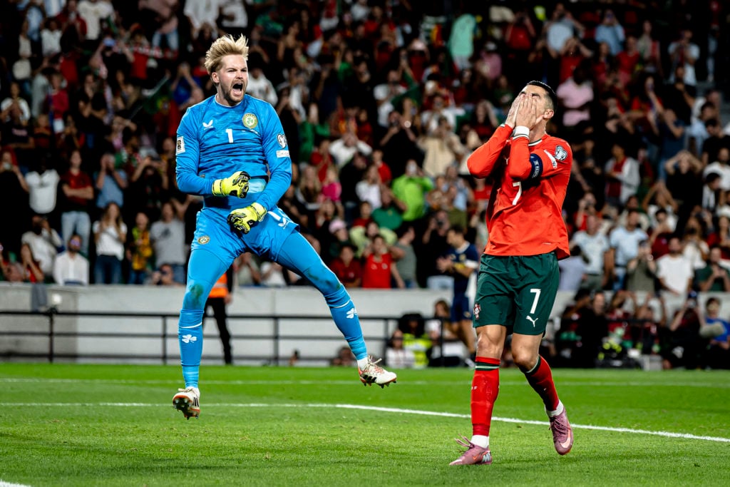 Caoimhin Kelleher celebrates after saving a penalty from Portugal's Cristiano Ronaldo during a FIFA World Cup qualifier with Ireland at the Estadio Jose Alvalade.