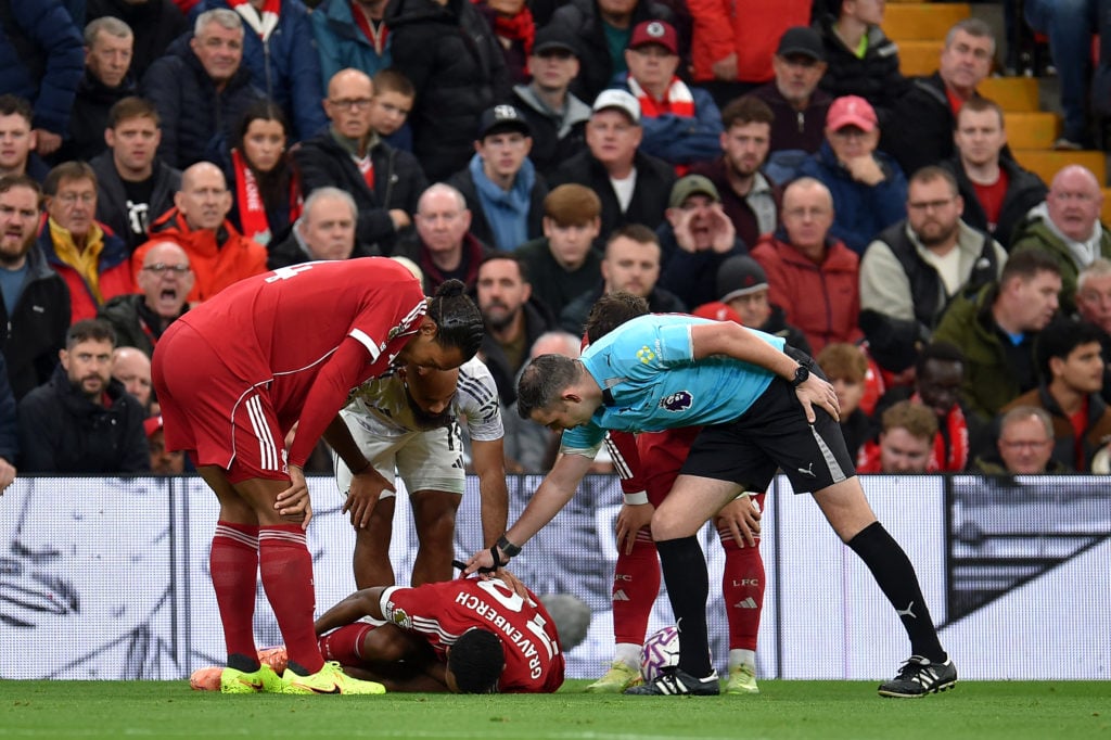 Ryan Gravenberch lies injured during Liverpool's Premier League match against Manchester United at Anfield.
