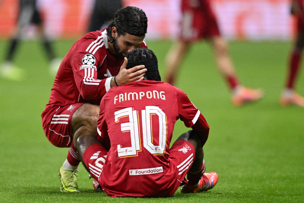 Liverpool's Hungarian midfielder #08 Dominik Szoboszlai checks on Liverpool's Dutch defender #30 Jeremie Frimpong who had to go off after sustaining an injury during the UEFA Champions League football match between Eintracht Frankfurt and Liverpool FC.