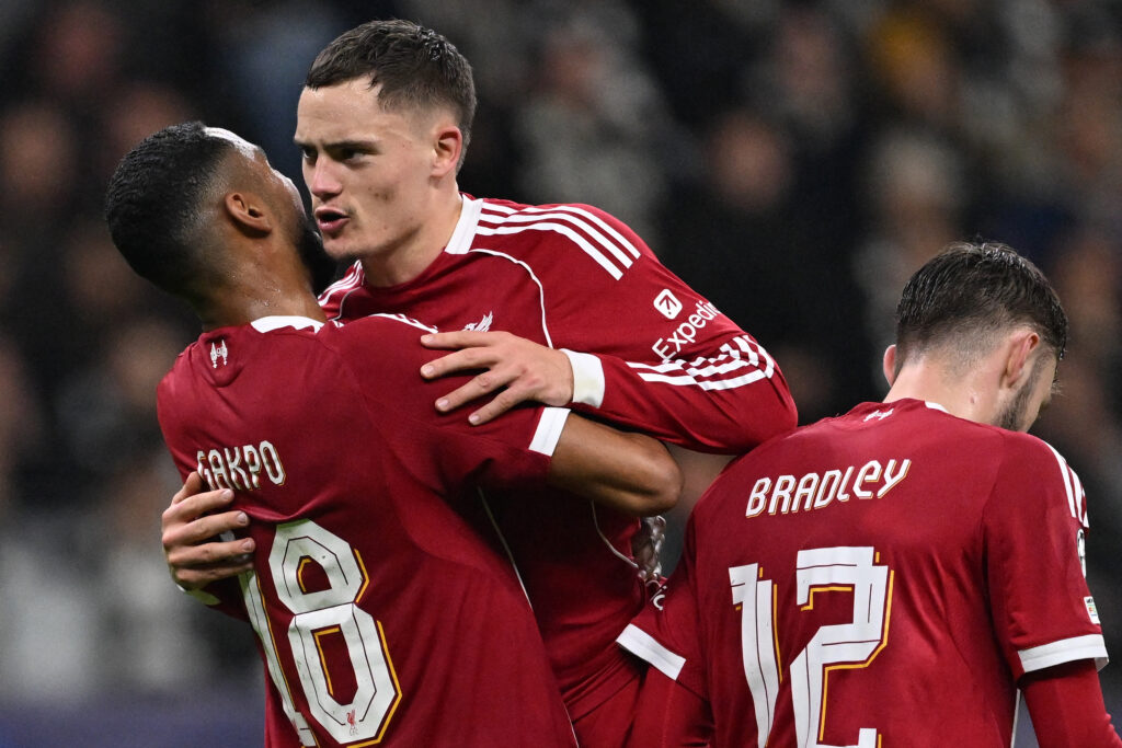Liverpool's Dutch striker #18 Cody Gakpo (L) celebrates scoring the 1-4 goal with his teammates including Liverpool's German midfielder #07 Florian Wirtz (C) during the UEFA Champions League football match.