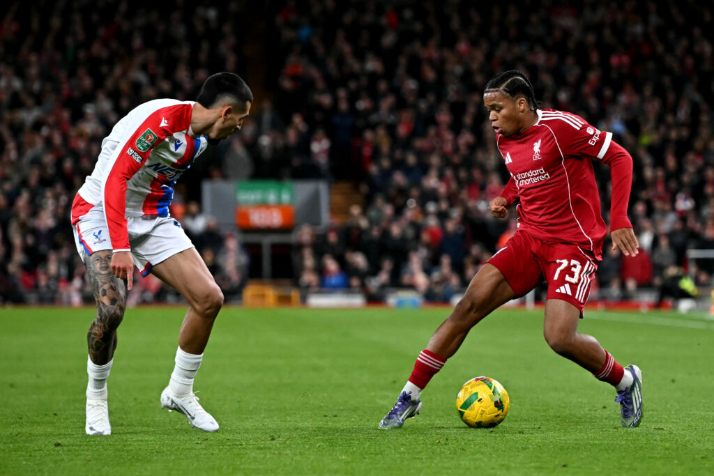 Liverpool's English striker #73 Rio Ngumoha battles for the ball with Crystal Palace's Colombian defender #02 Daniel Munoz during the English League Cup fourth round football match between Liverpool and Crystal Palace at Anfield.