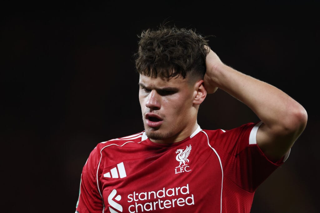 Milos Kerkez of Liverpool reacts after clashing heads with Daniel Munoz of Crystal Palace (not pictured) during the Carabao Cup Fourth Round match between Liverpool and Crystal Palace at Anfield.