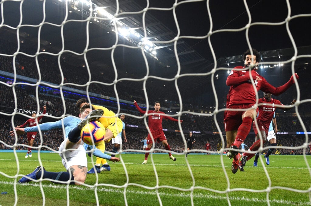 John Stones of Manchester City makes a goal line clearance during the Premier League match between Manchester City and Liverpool FC at the Etihad Stadium