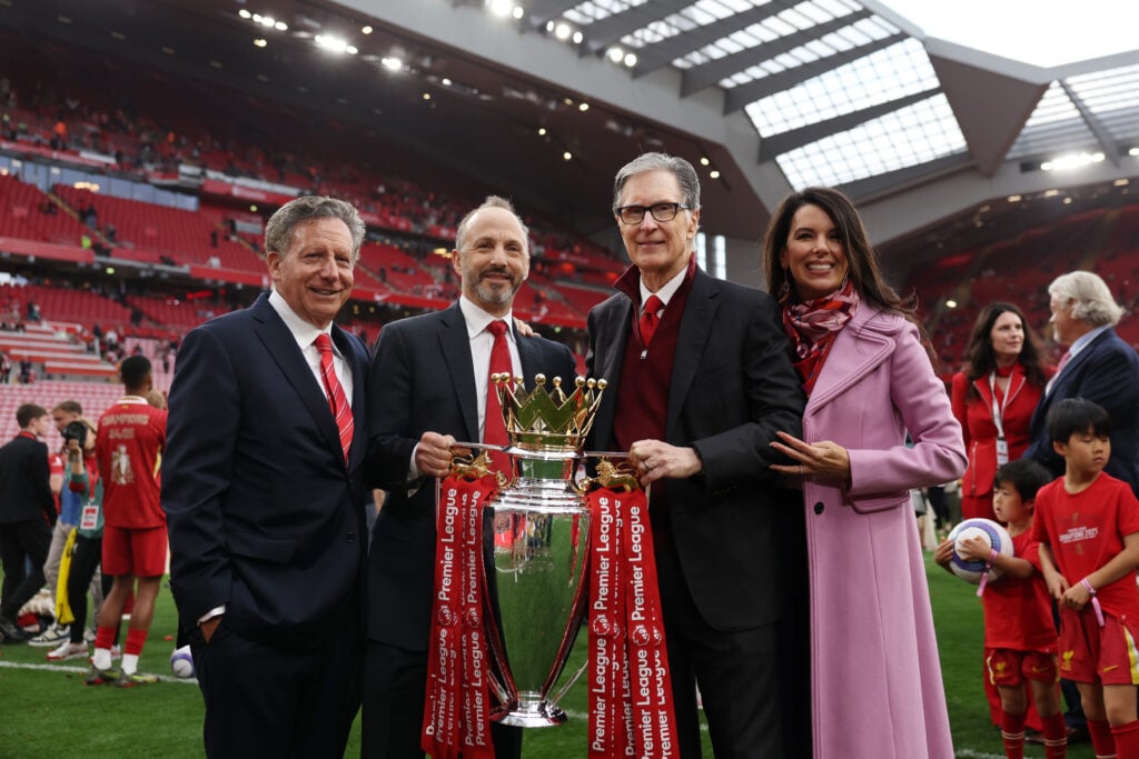 John Henry, Mike Gordon and Tom Werner hold the Premier League trophy at Anfield