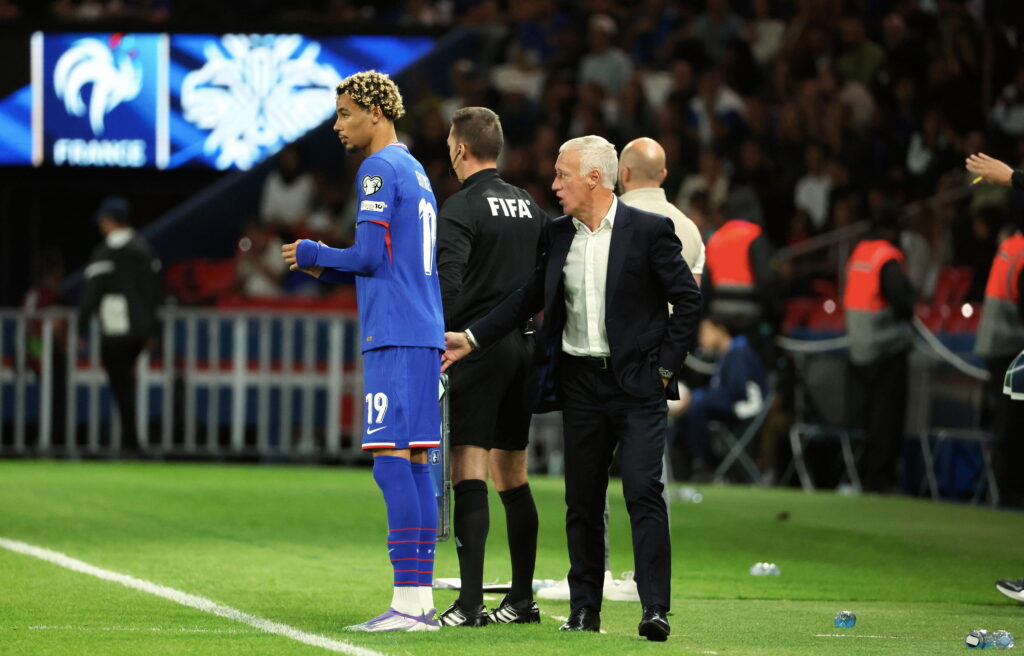 Hugo Ekitike prepares to come on as a substitute during France's FIFA World Cup qualifying match against Iceland as Didier Deschamps watches on.