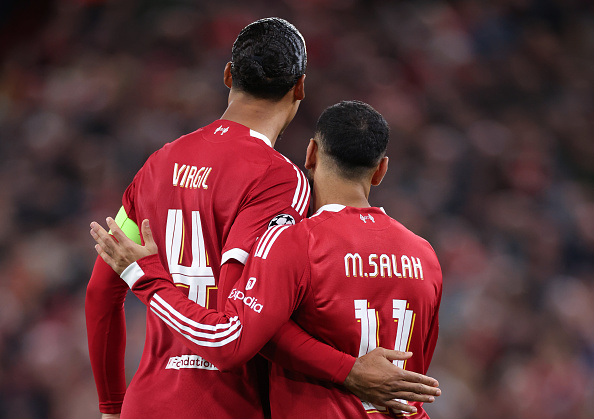 Mohamed Salah of Liverpool celebrates with Virgil van Dijk during the UEFA Champions League 2025/26 League Phase MD1 match between Liverpool FC and Atletico de Madrid at Anfield
