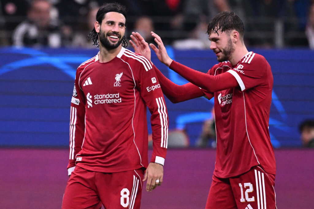 Liverpool's Hungarian midfielder #08 Dominik Szoboszlai (L) celebrates scoring the 1-5 goal with his teammate Liverpool's Northern Irish defender #12 Conor Bradley during the UEFA Champions League football match between Eintracht Frankfurt and Liverpool FC in Frankfurt