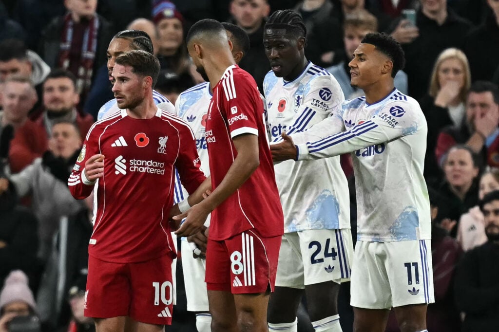 Liverpool's Argentinian midfielder #10 Alexis Mac Allister and Liverpool's Hungarian midfielder #08 Dominik Szoboszlai take Aston Villa's English striker #11 Ollie Watkins (R) reacts as their positions in front of the Aston Villa wall ahead of a free kick, during the English Premier League football match between Liverpool and Aston Villa at Anfield