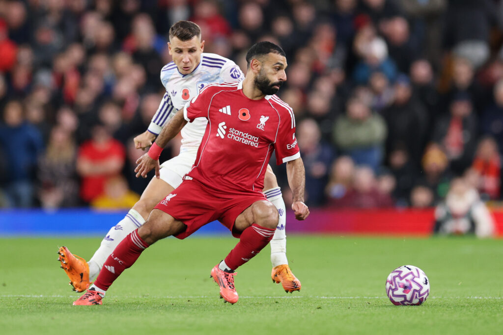 Mohamed Salah of Liverpool battles for possession with Lucas Digne of Aston Villa during the Premier League match between Liverpool and Aston Villa at Anfield.