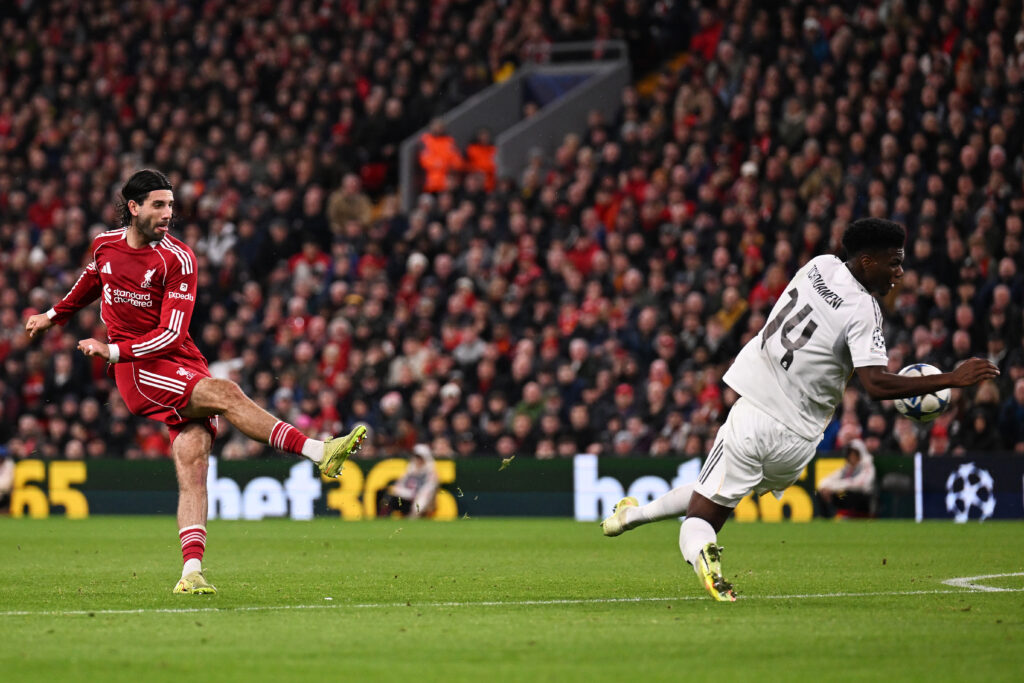 Dominik Szoboszlai of Liverpool takes a shot which strikes the hand of Aurelien Tchouameni of Real Madrid resulting in a free kick during the UEFA Champions League 2025/26 League Phase MD4 match between Liverpool FC and Real Madrid C.F. at Anfield