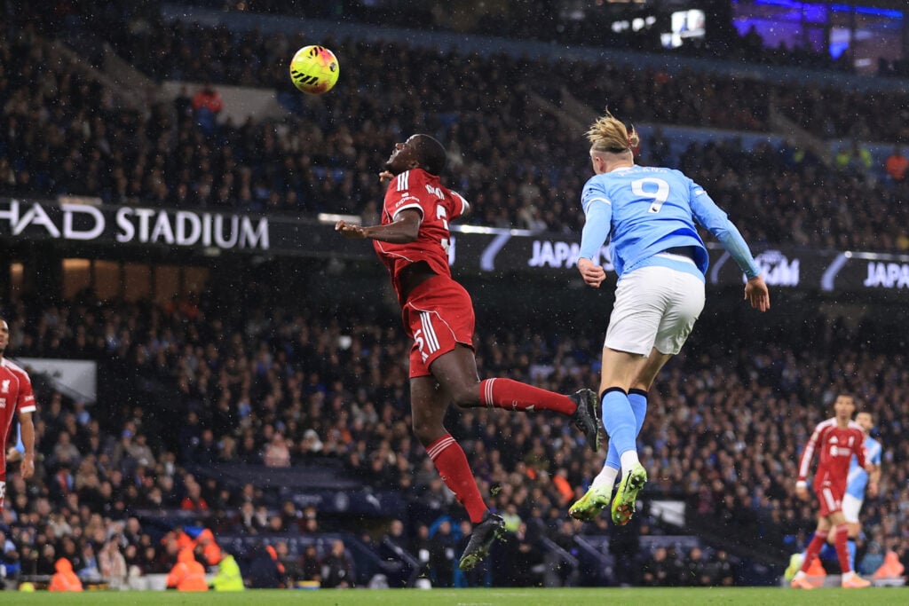 Ibrahima Konate of Liverpool is beaten to the ball by Erling Haaland of Manchester City who heads the opening goal during the Premier League match between Manchester City and Liverpool at Etihad Stadium