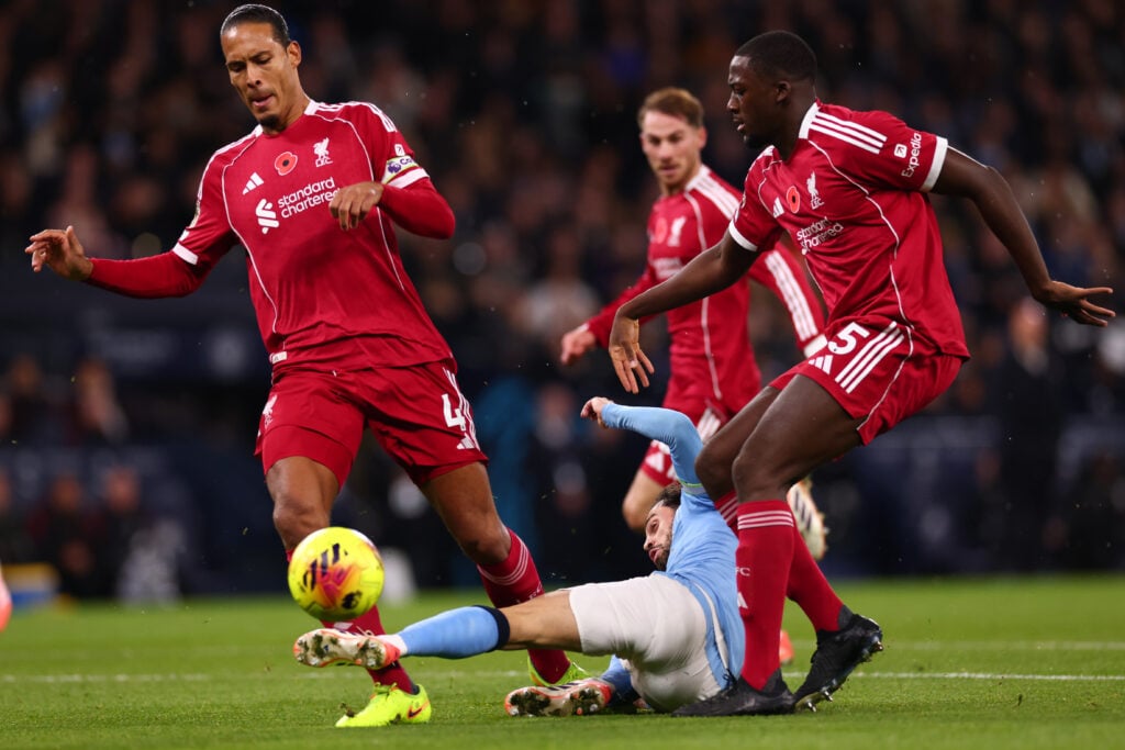 Virgil van Dijk of Liverpool is fouled by Bernardo Silva of Manchester City during the Premier League match between Manchester City and Liverpool at Etihad Stadium