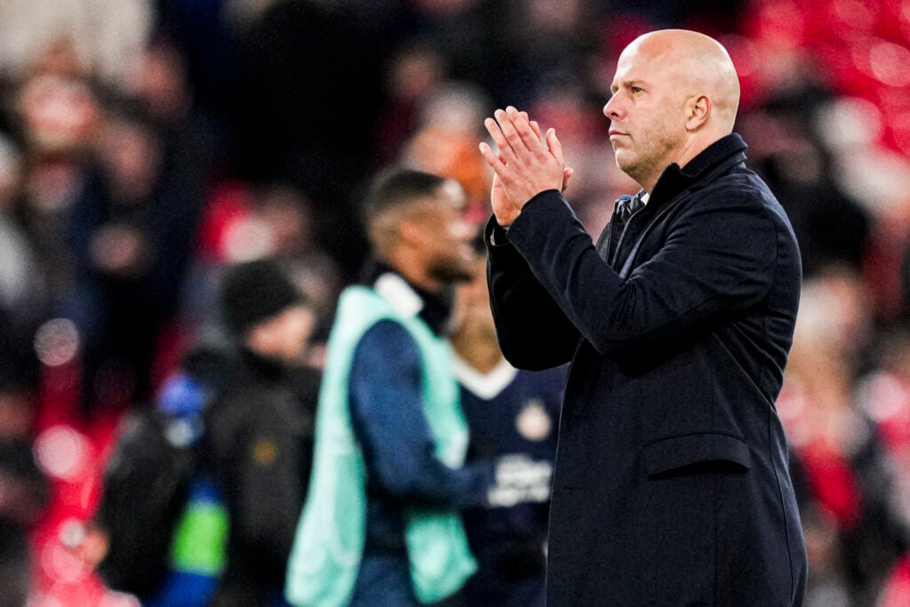 Arne Slot applauds Anfield after Liverpool's UEFA Champions League match against PSV Eindhoven.