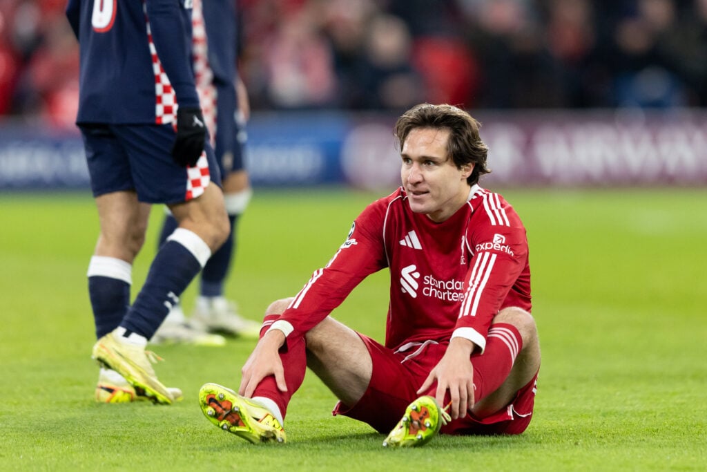 Federico Chiesa sits on the Anfield turf during Liverpool's UEFA Champions League match against PSV Eindhoven