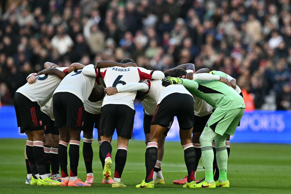 Liverpool players hold a group huddle on the pitch ahead of kick-off in the English Premier League football match between West Ham United and Liverpool at the London Stadium