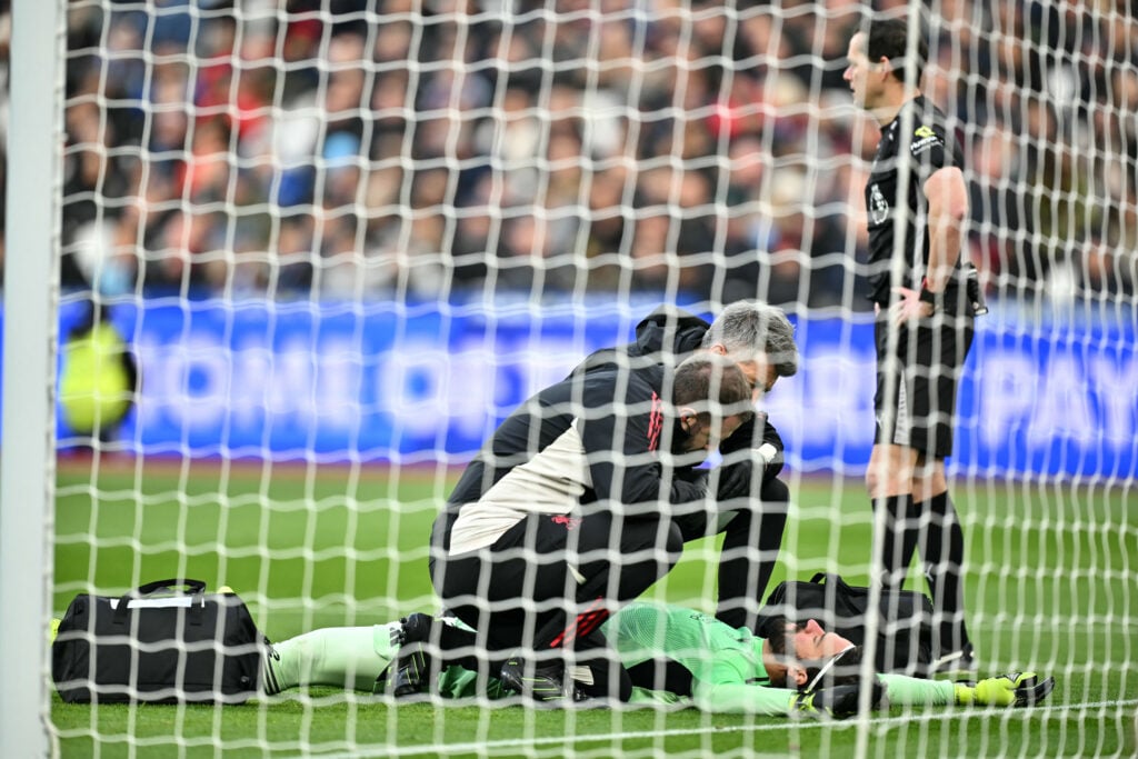 Alisson Becker receives treatment during Liverpool's Premier League match against West Ham United at the London Stadium.