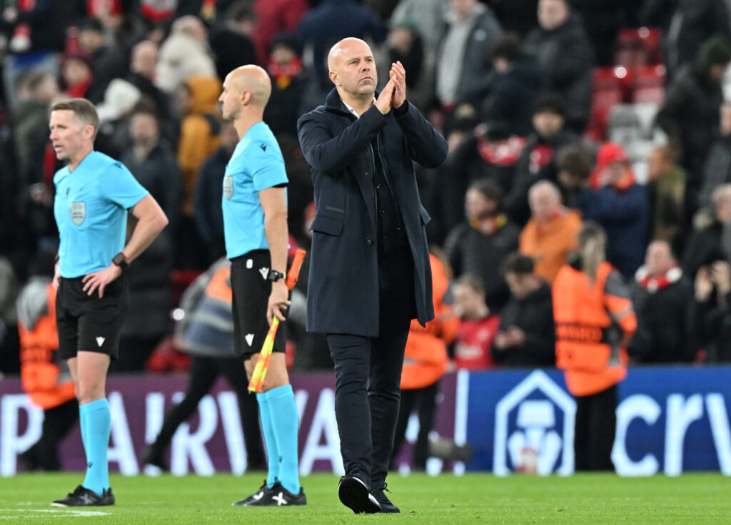 Arne Slot applauds fans after Liverpool's UEFA Champions League loss against PSV Eindhoven at Anfield.