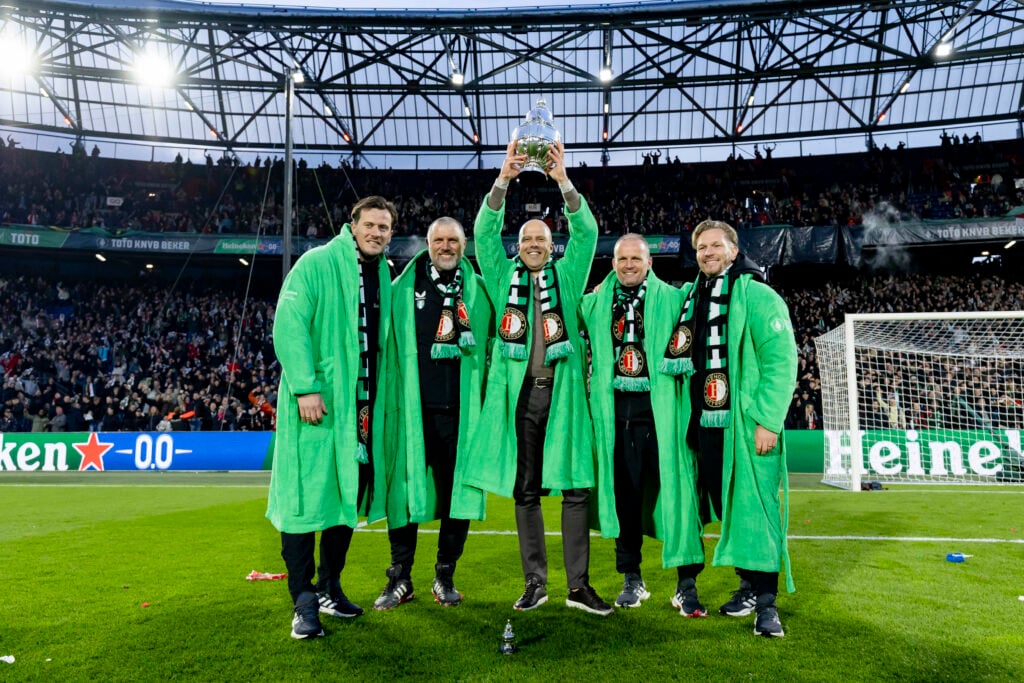assistant trainer Etienne Reijnen of Feyenoord, assistant trainer John de Wolf of Feyenoord, coach Arne Slot of Feyenoord, assistant trainer Sipke Hulshof of Feyenoord, goalkeeper coach Jyri Nieminen of Feyenoord celebrating the victory with the TOTO KNVB trophy during the Dutch KNVB Beker match between Feyenoord v NEC Nijmegen at the Stadium Feijenoord