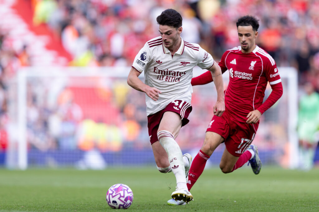 Declan Rice runs with the ball as Curtis Jones chases him during Liverpool's Premier League match against Arsenal at Anfield.