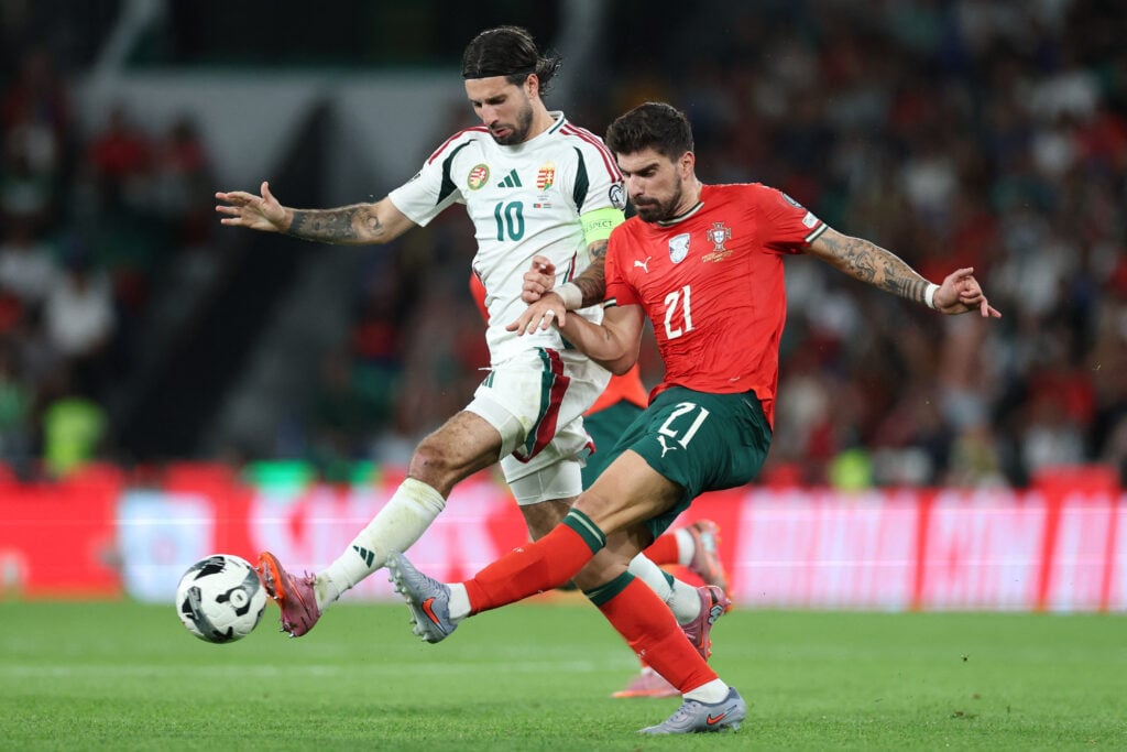Ruben Neves and Dominik Szoboszlai battle for the ball during the FIFA World Cup Qualifying match between Portugal and Hungary at the Estadio Jose Alvalade.