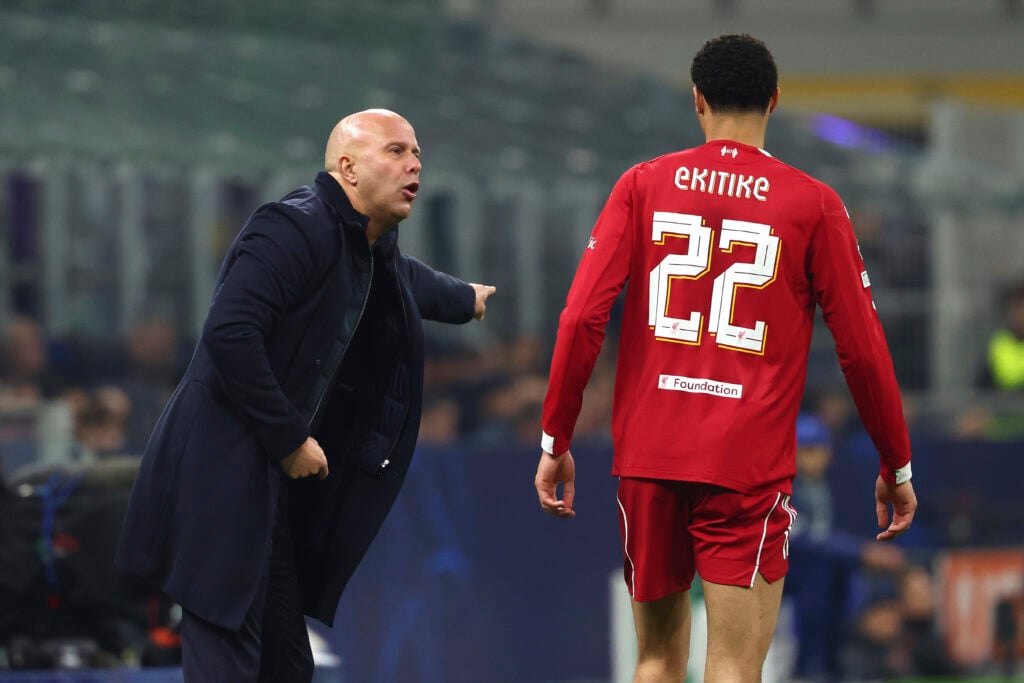 Arne Slot shouts instructions as Hugo Ekitike walks past him during Liverpool's UEFA Champions League match against Inter Milan at San Siro.