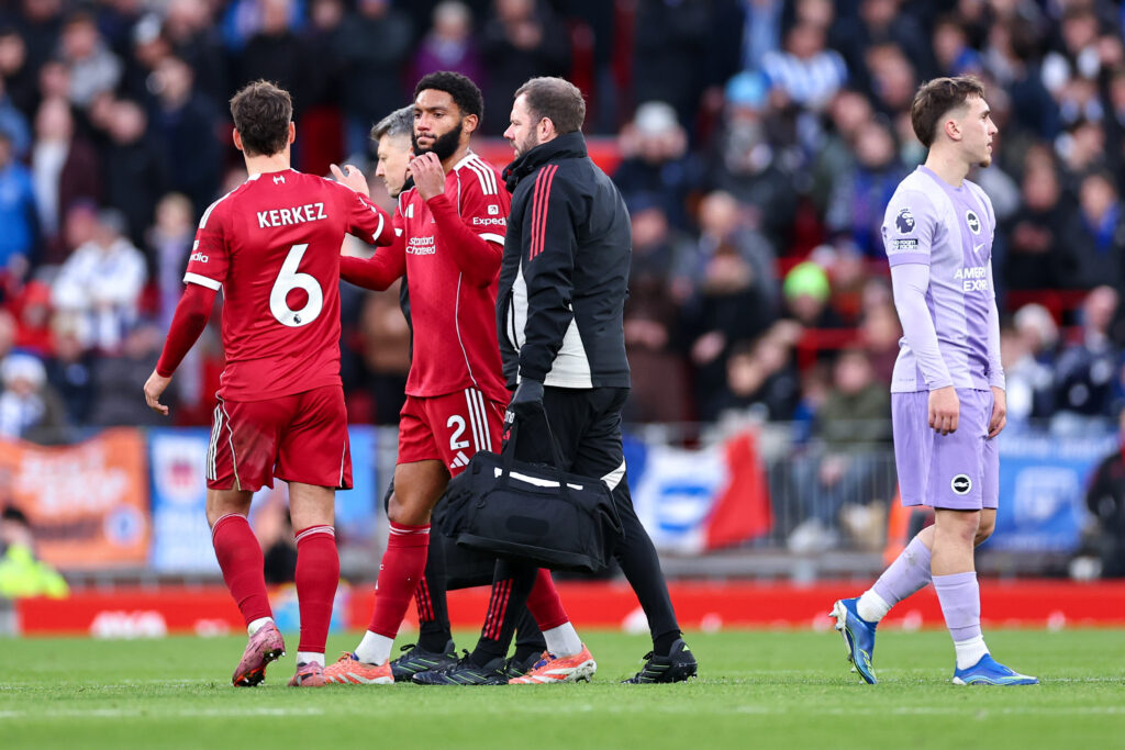 Joe Gomez high fives Milos Kerkez as he leaves the pitch with an injury during Liverpool's Premier League match against Brighton at Anfield.