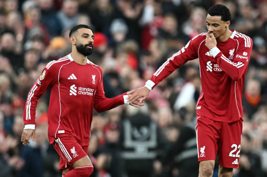 Hugo Ekitike taps hands with Mohamed Salah as he comes off of the bench to play during the English Premier League football match between Liverpool and Brighton and Hove Albion