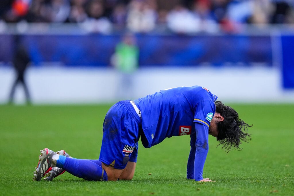 Takumi Minamini goes down with an injury during Monaco's French Cup match against Auxerre.