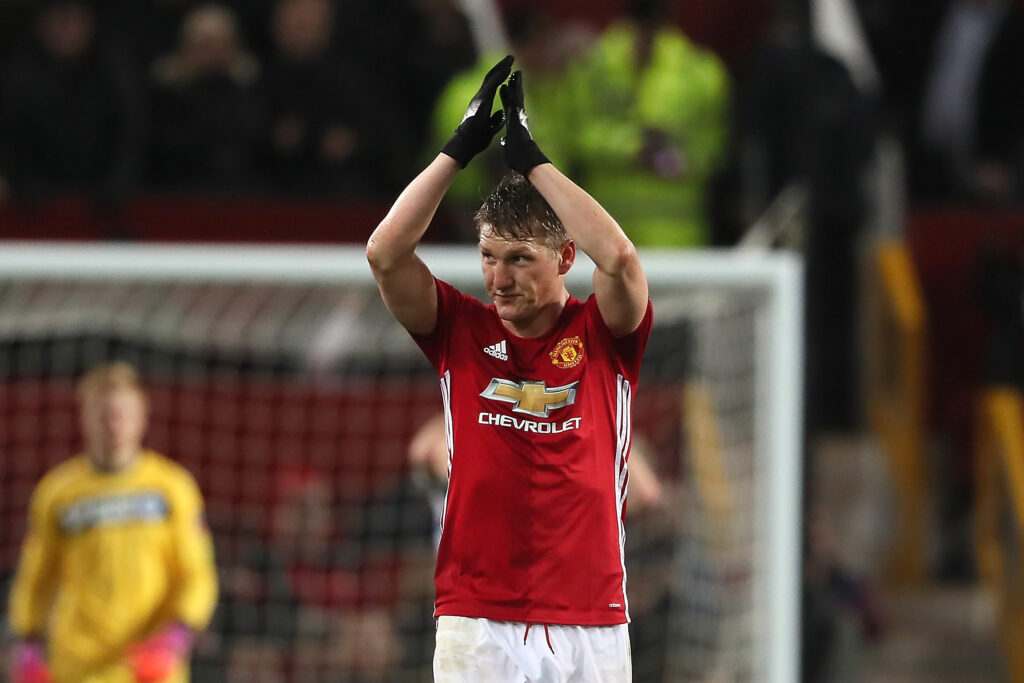 Bastian Schweinsteiger of Manchester United celebrates scoring his team's fourth goal to make the score 4-0 during the FA Cup fourth round match between Manchester United and Wigan Athletic at Old Trafford