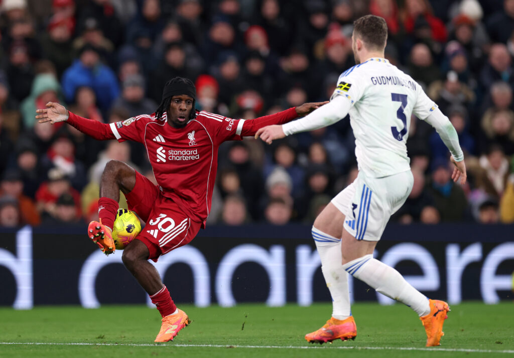 Jeremie Frimpong of Liverpool controls the ball whilst under pressure from Gabriel Gudmundsson of Leeds United (obscured) during the Premier League match between Liverpool and Leeds United at Anfield