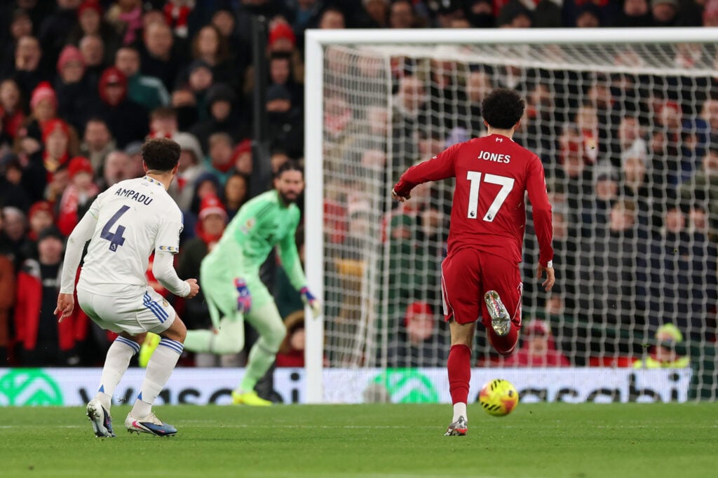 Ethan Ampadu of Leeds United shoots whilst under pressure from Curtis Jones of Liverpool as Alisson Becker of Liverpool runs back towards goal during the Premier League match between Liverpool and Leeds United at Anfield