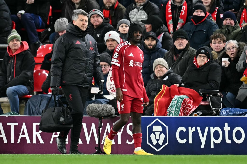 Jeremie Frimpong walks off the pitch injured during Liverpool's UEFA Champions League match against Qarabag at Anfield
