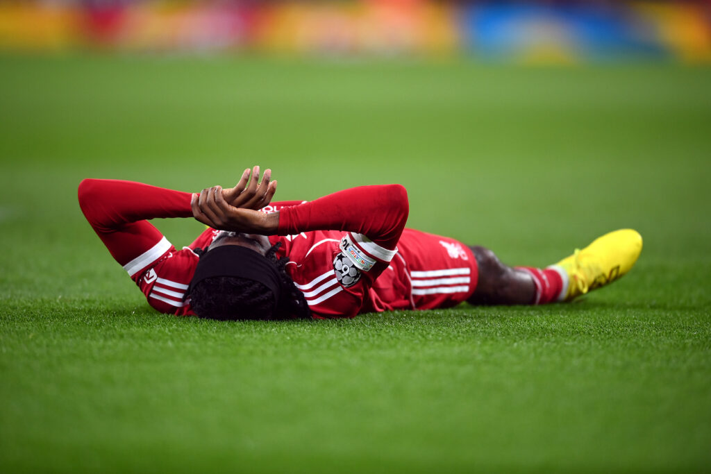 Jeremie Frimpong lies stricken on the Anfield pitch after picking up an injury during Liverpool's UEFA Champions League match against Qarabag
