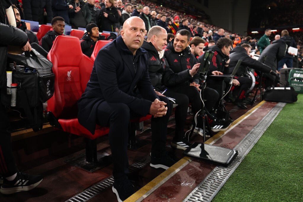 Arne Slot sits on the bench with the Liverpool coaching staff ahead of the UEFA Champions League match at Anfield against Qarabag
