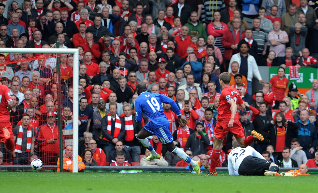 Demba Ba scores for Chelsea against Liverpool during the Premier League match at Anfield.