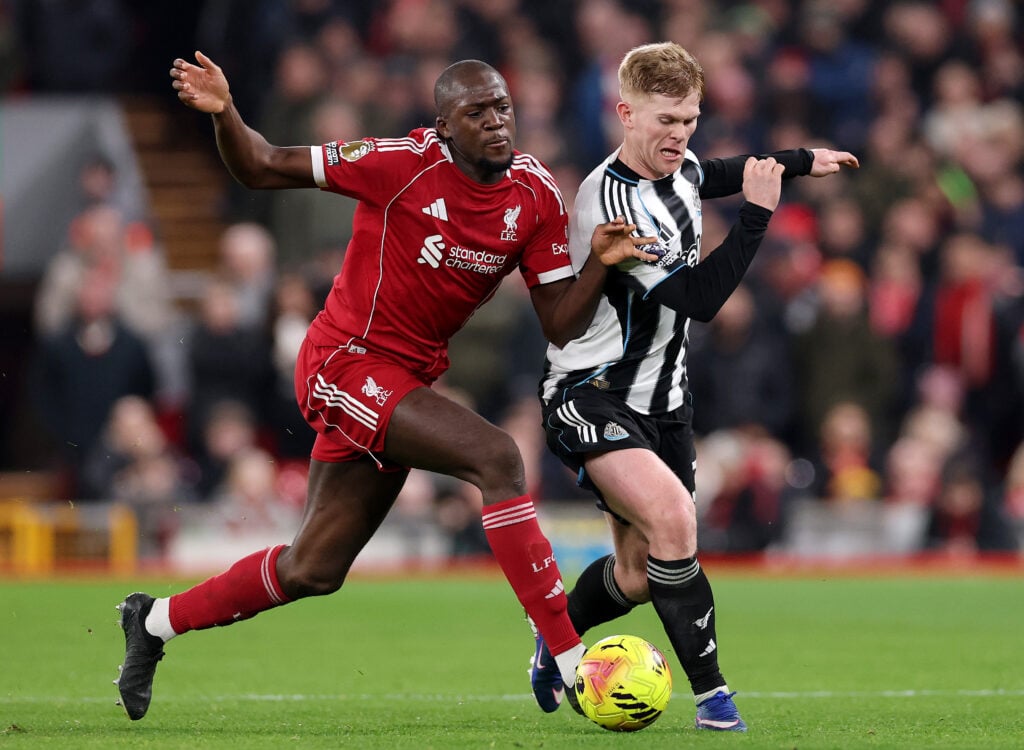 Ibrahima Konate challenges Lewis Hall for the ball during Liverpool's Premier League match against Newcastle United at Anfield.