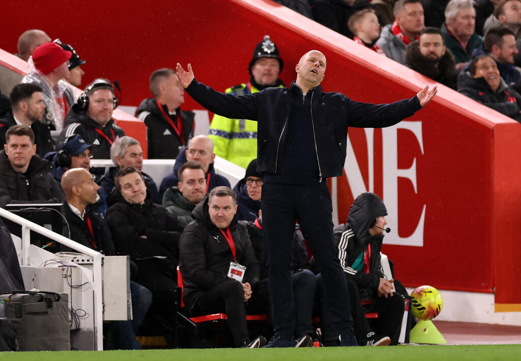 Arne Slot throws his arms wide during Liverpool's Premier League match against Manchester City at Anfield.