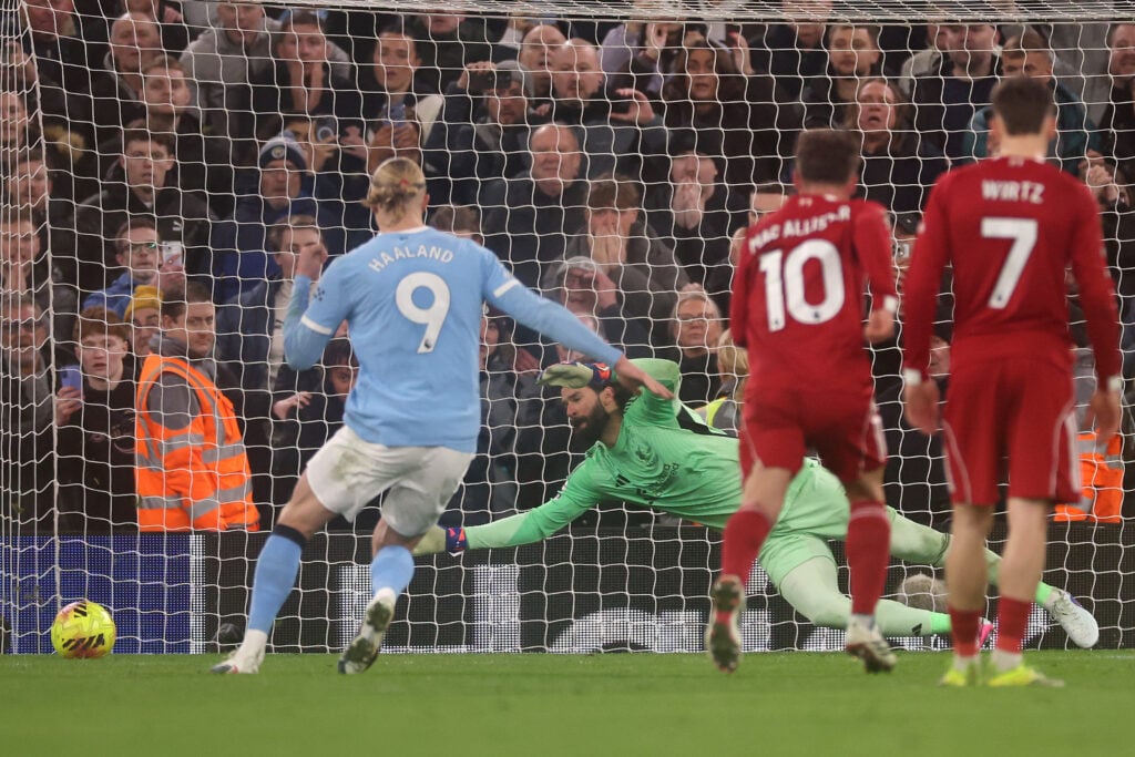 Erling Haaland scores a penalty for Manchester City against Liverpool at Anfield in the Premier League.