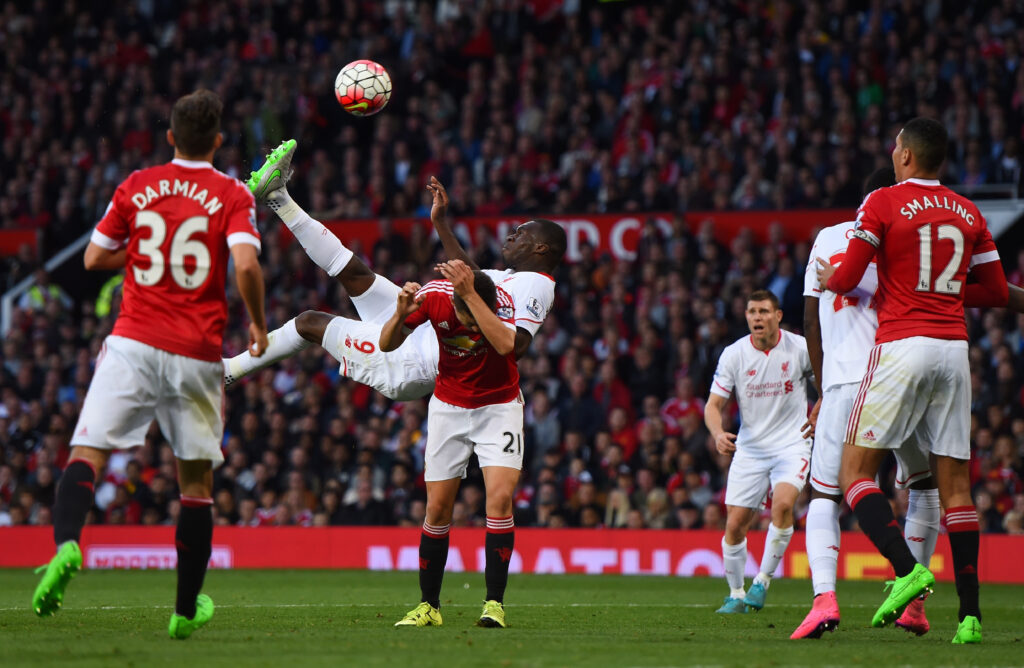 Christian Benteke scores with an overhead kick during Liverpool's Premier League match against Manchester United at Old Trafford.